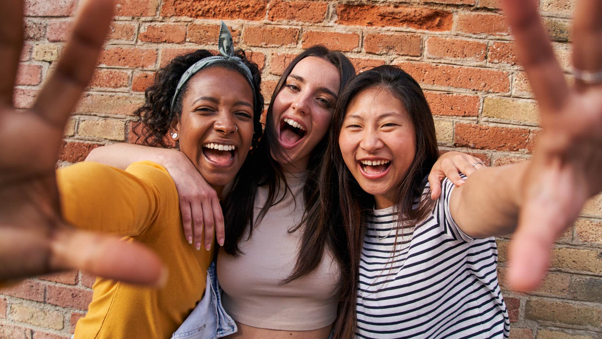 Happy friends take selfie showing thing extroverts better at