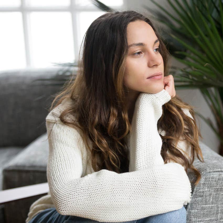 Woman who's incredibly reflective sitting alone at home