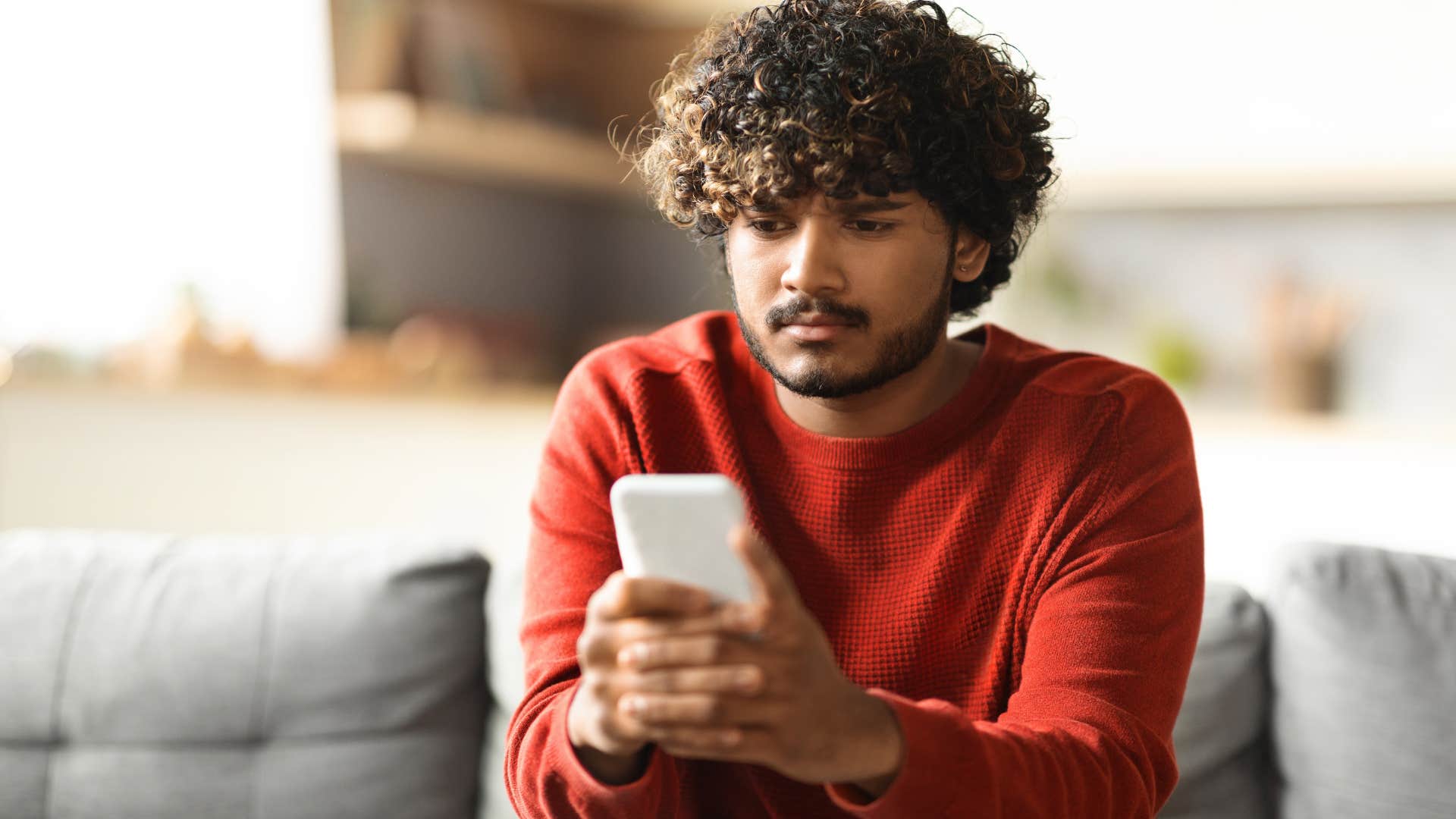 easily distracted man looking at his phone