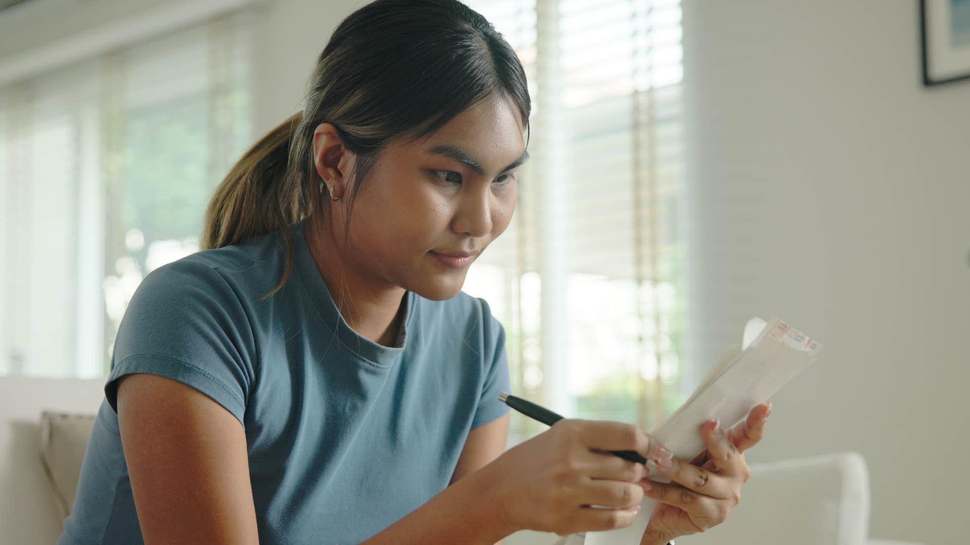 woman being intentional with her time writing on paper
