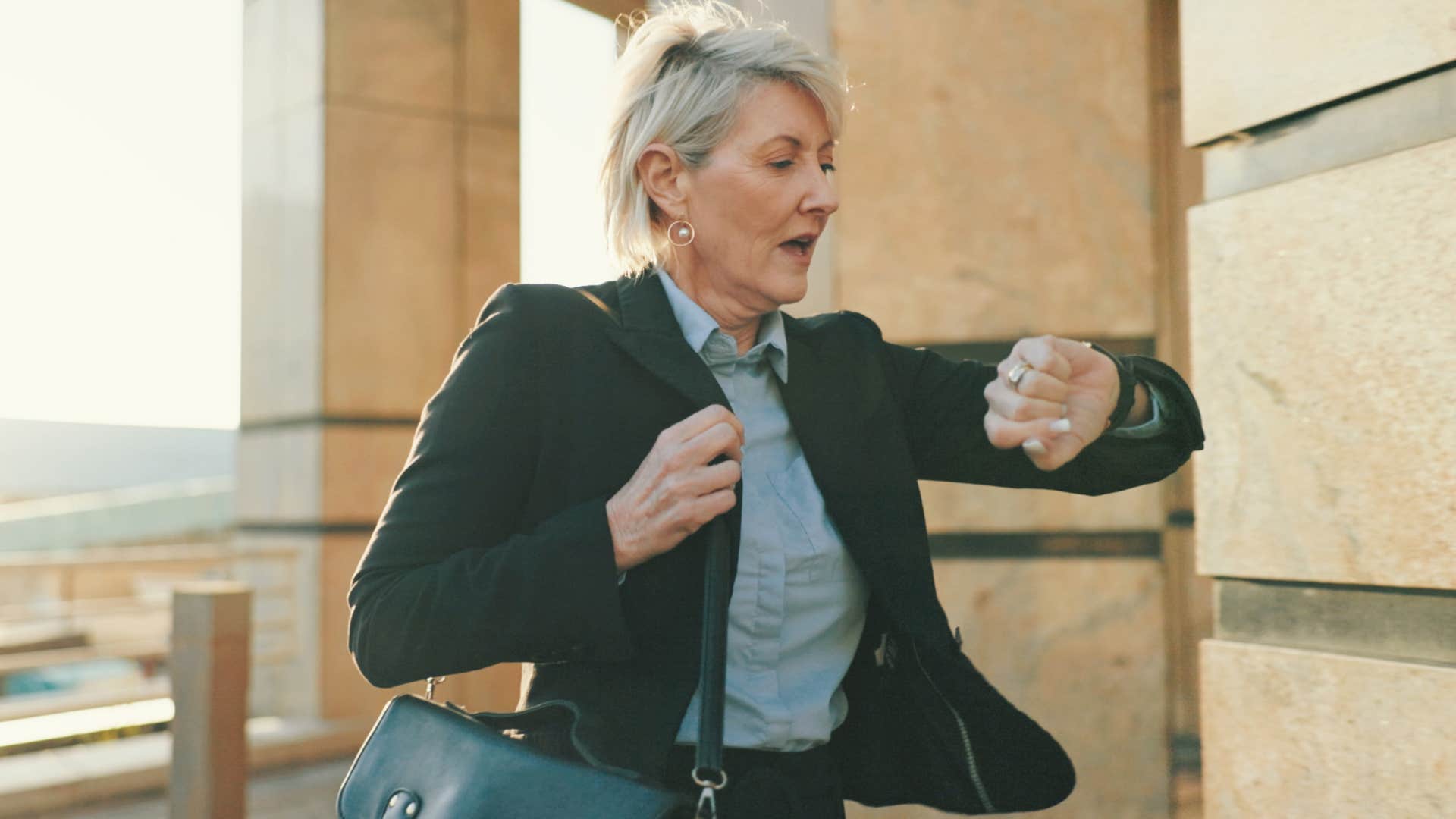 woman who struggles to manage time looking at her watch