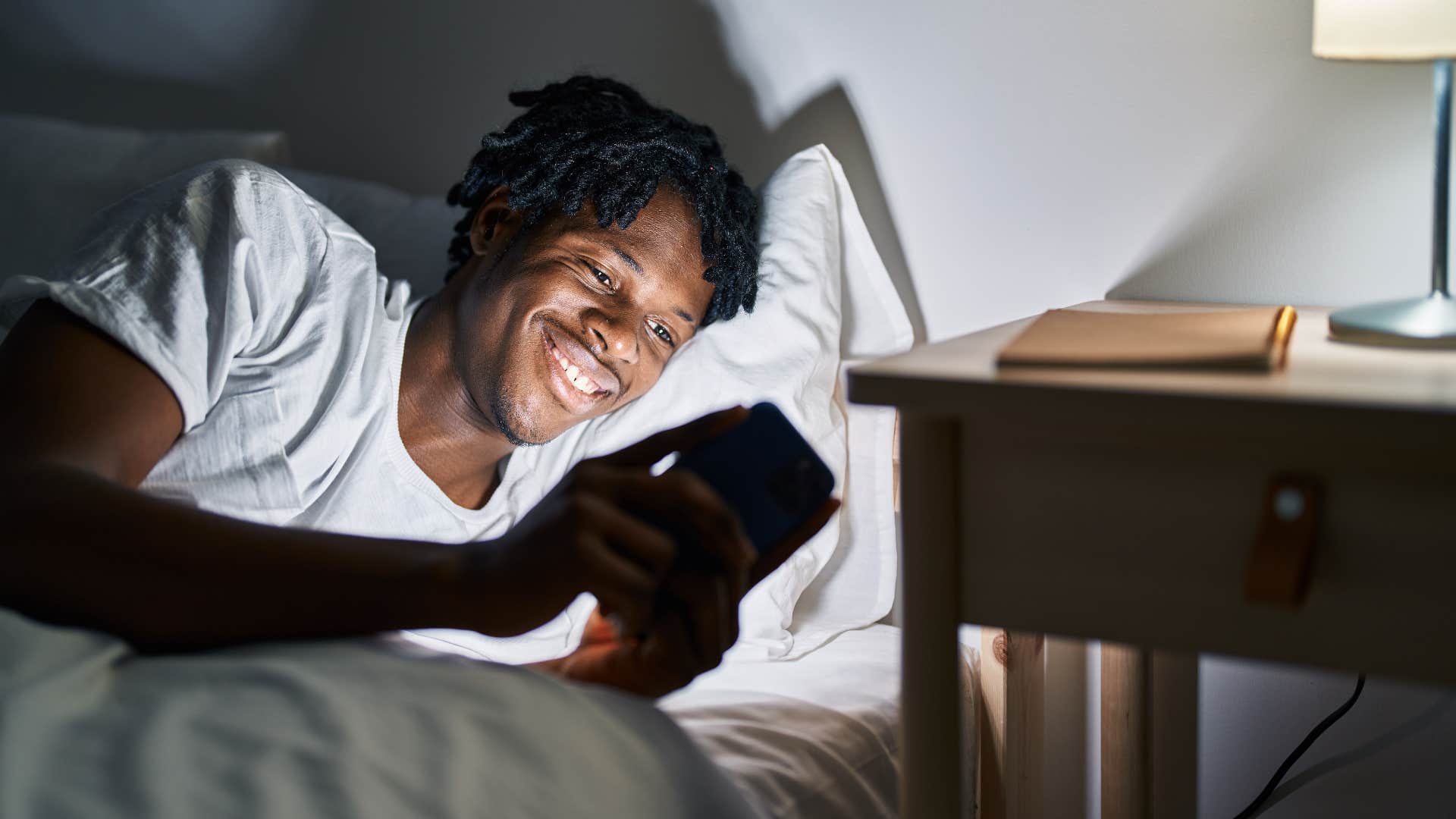 man on his phone before bed