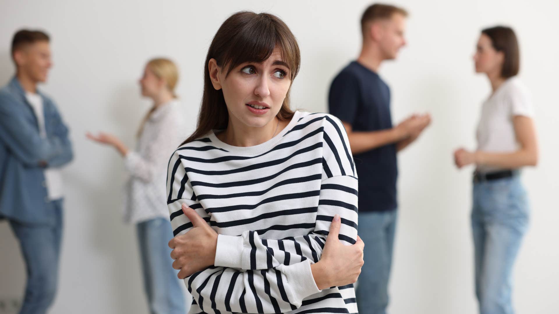 self-conscious woman feeling awkward around other people talking