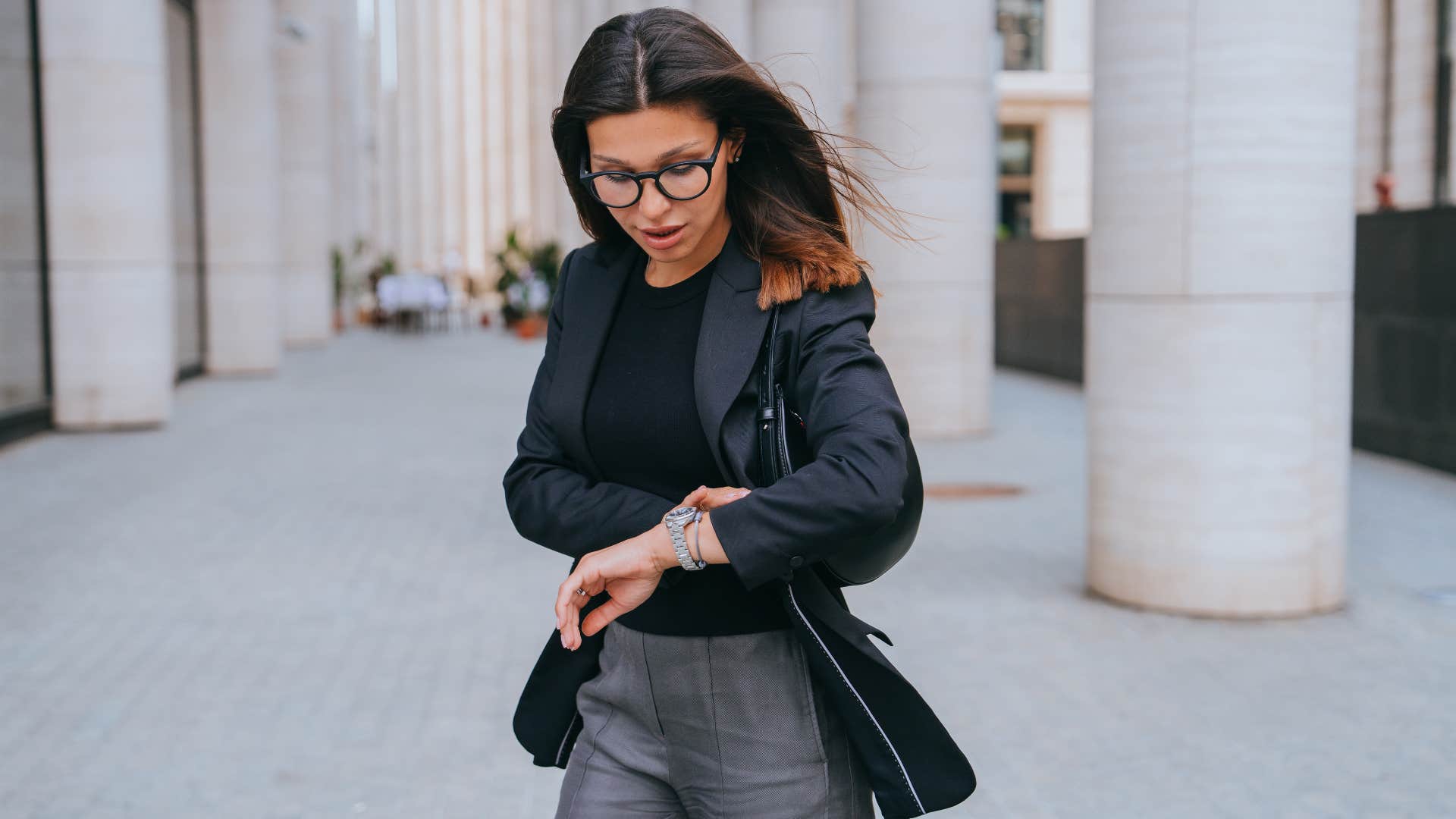 woman who is time conscious looking at watch