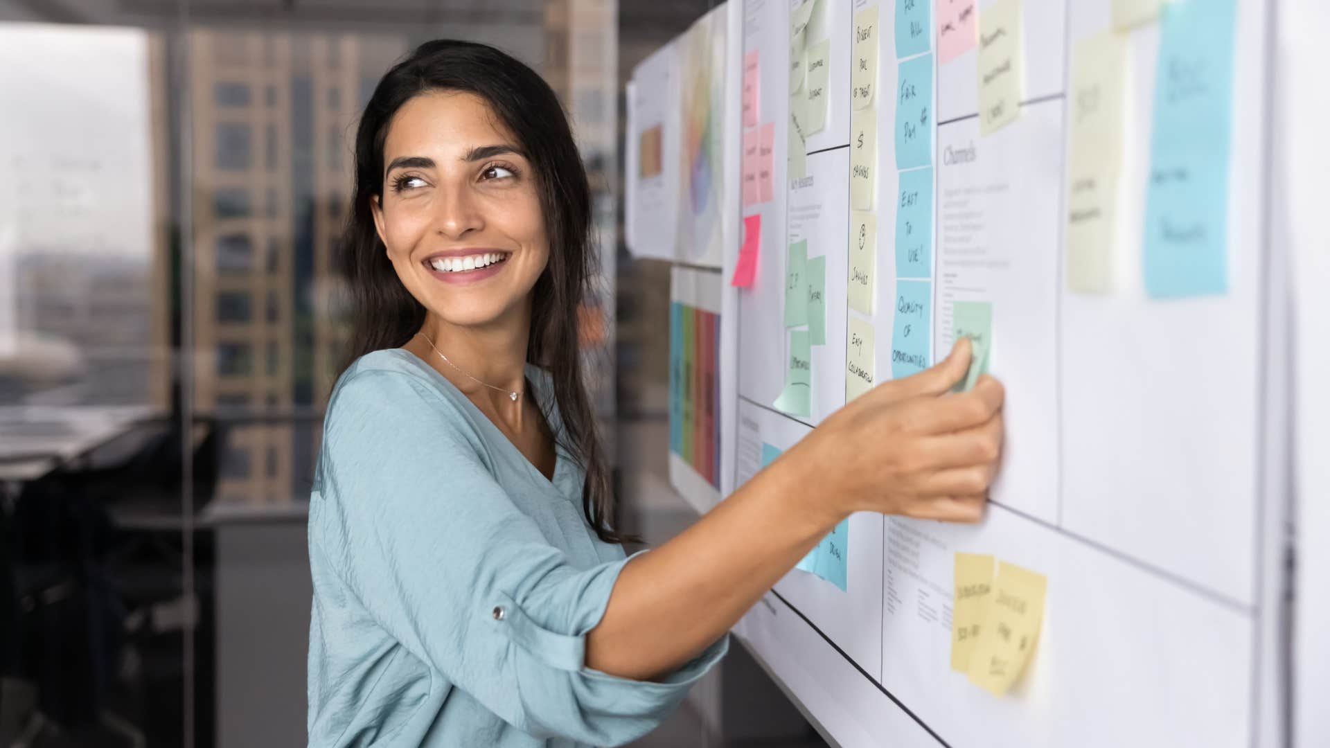 woman putting sticky notes on calendar