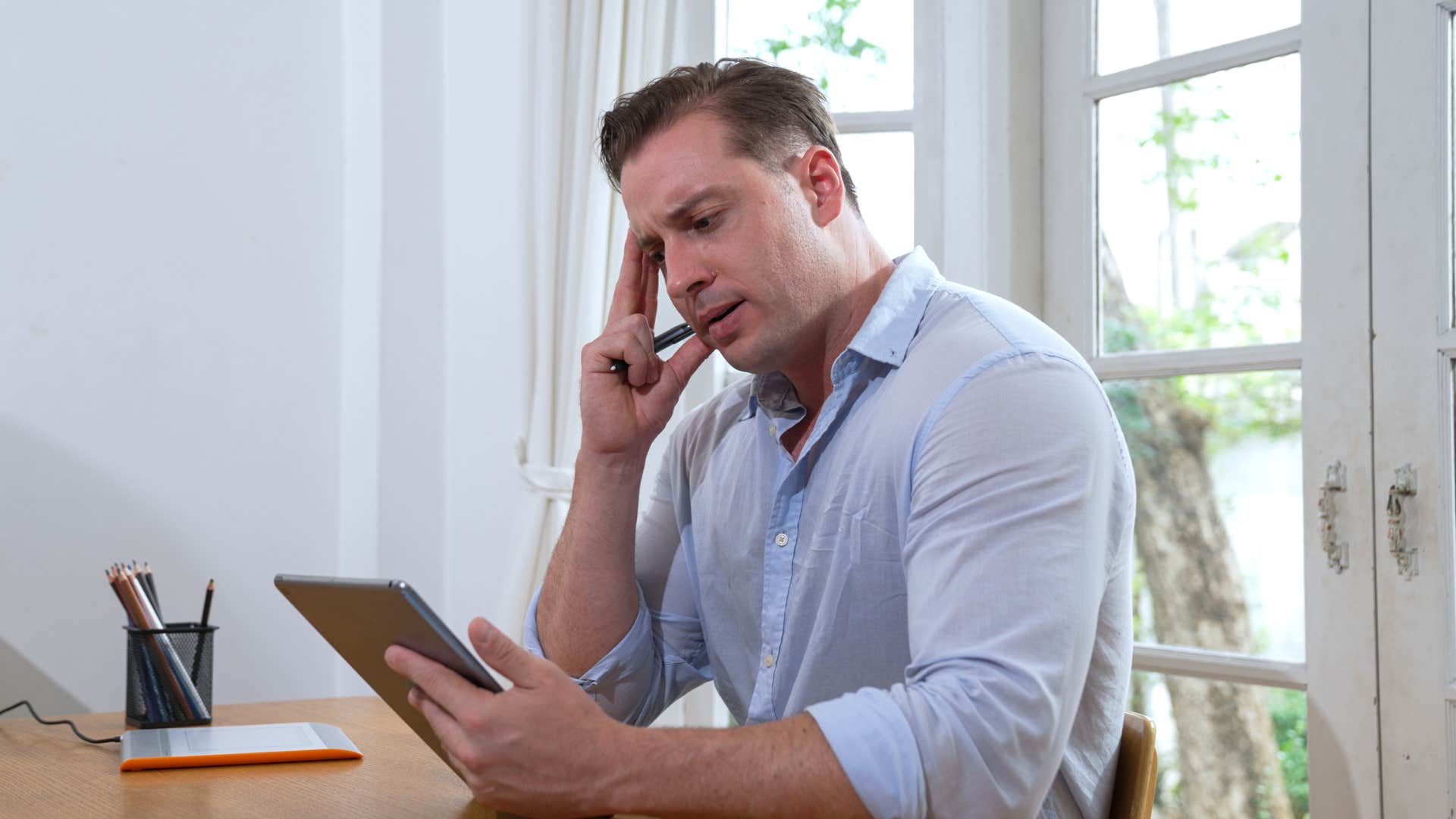 man thinking struggling to make decisions while working