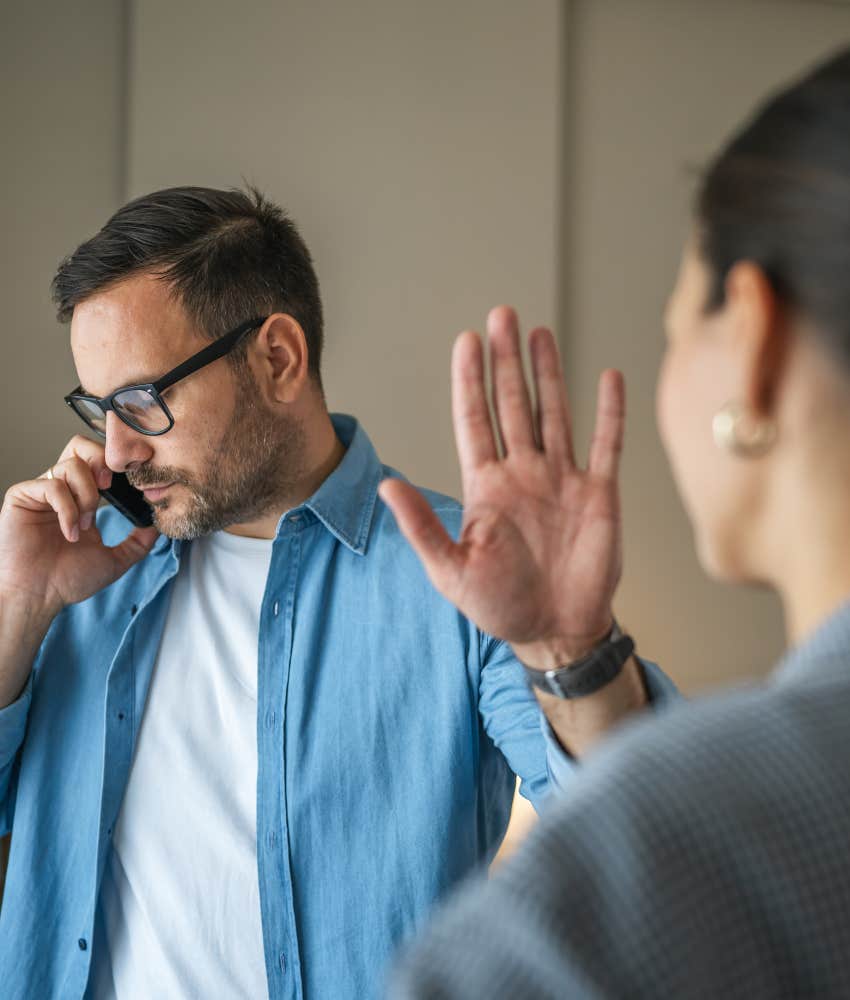 Closed person on phone puts up hand showing struggle with trust
