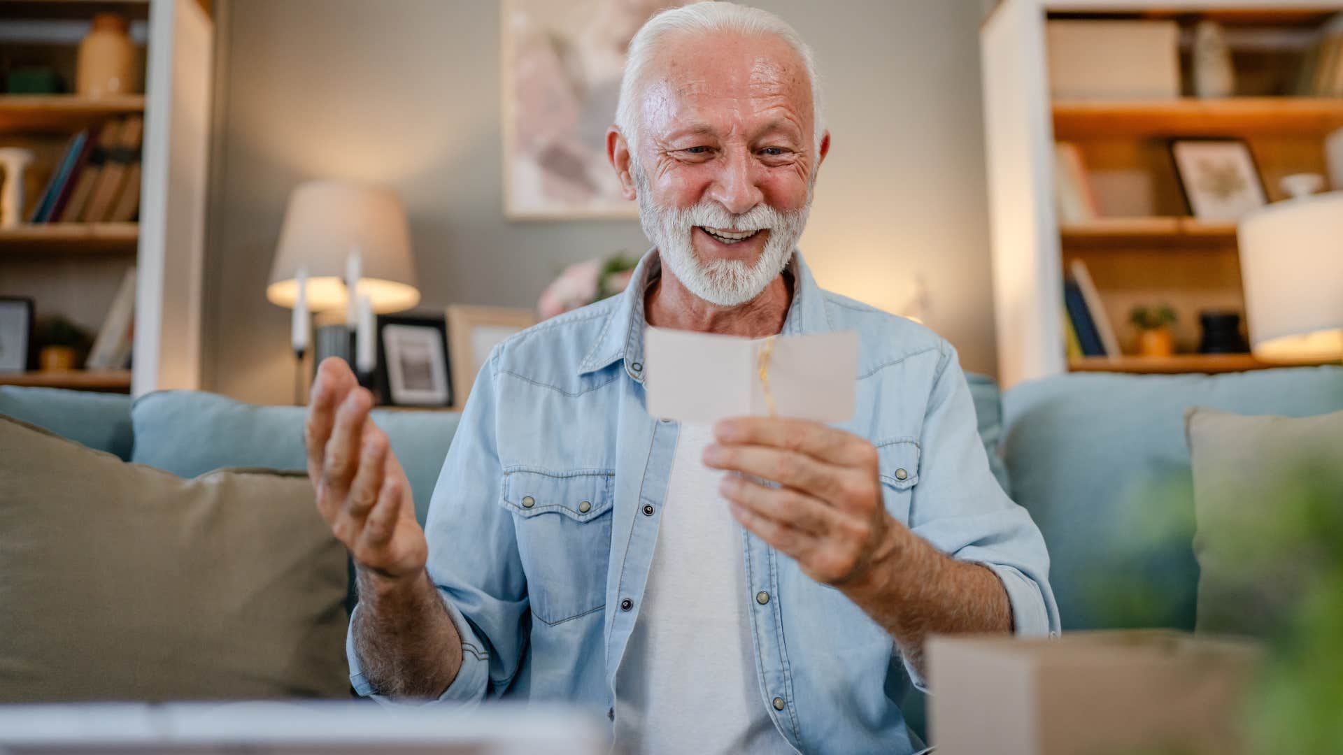 sentimental man looking at old letters on his couch