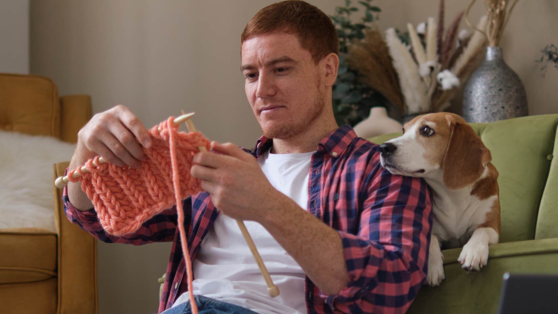 very creative man knitting at home