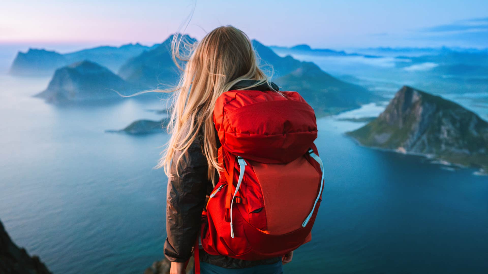 Inspired person on mountain top showing emotional gift