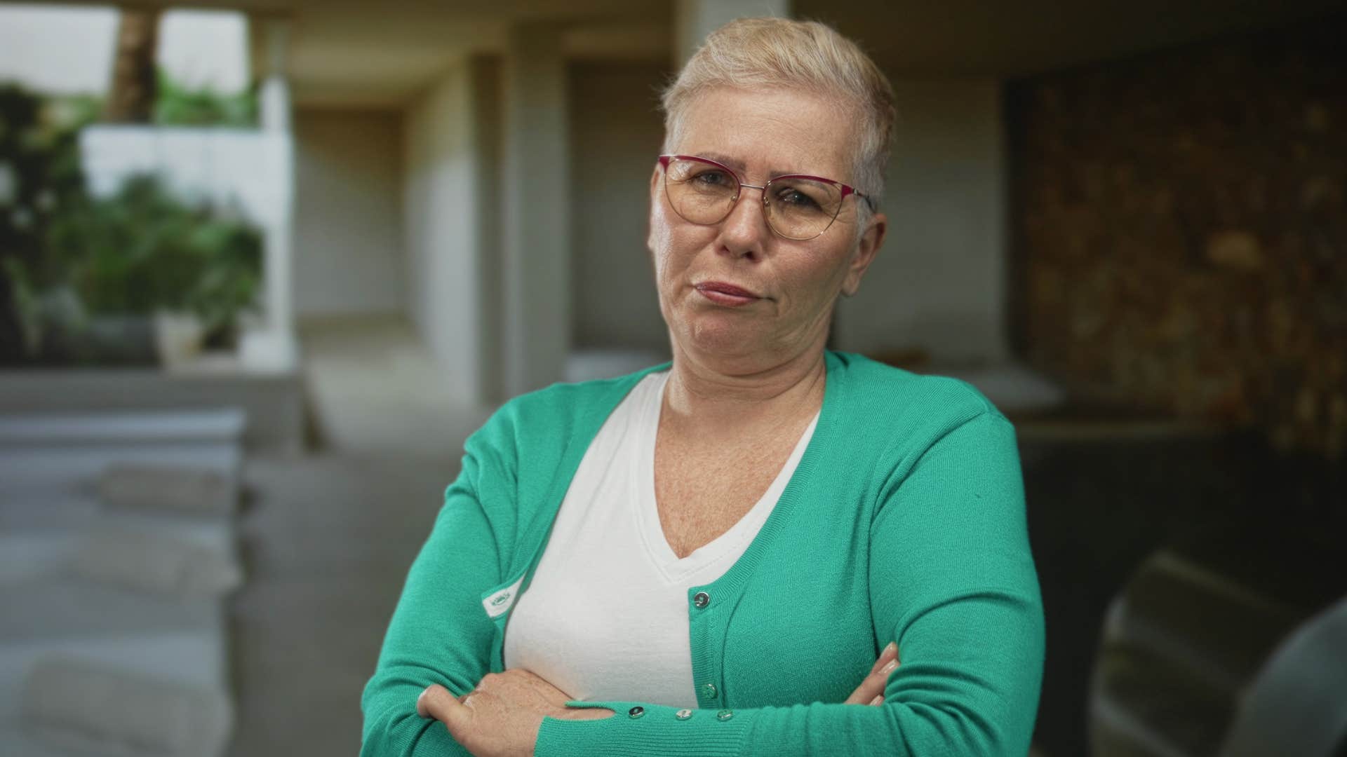Serious person with crossed arms showing emotional gift facing jugment