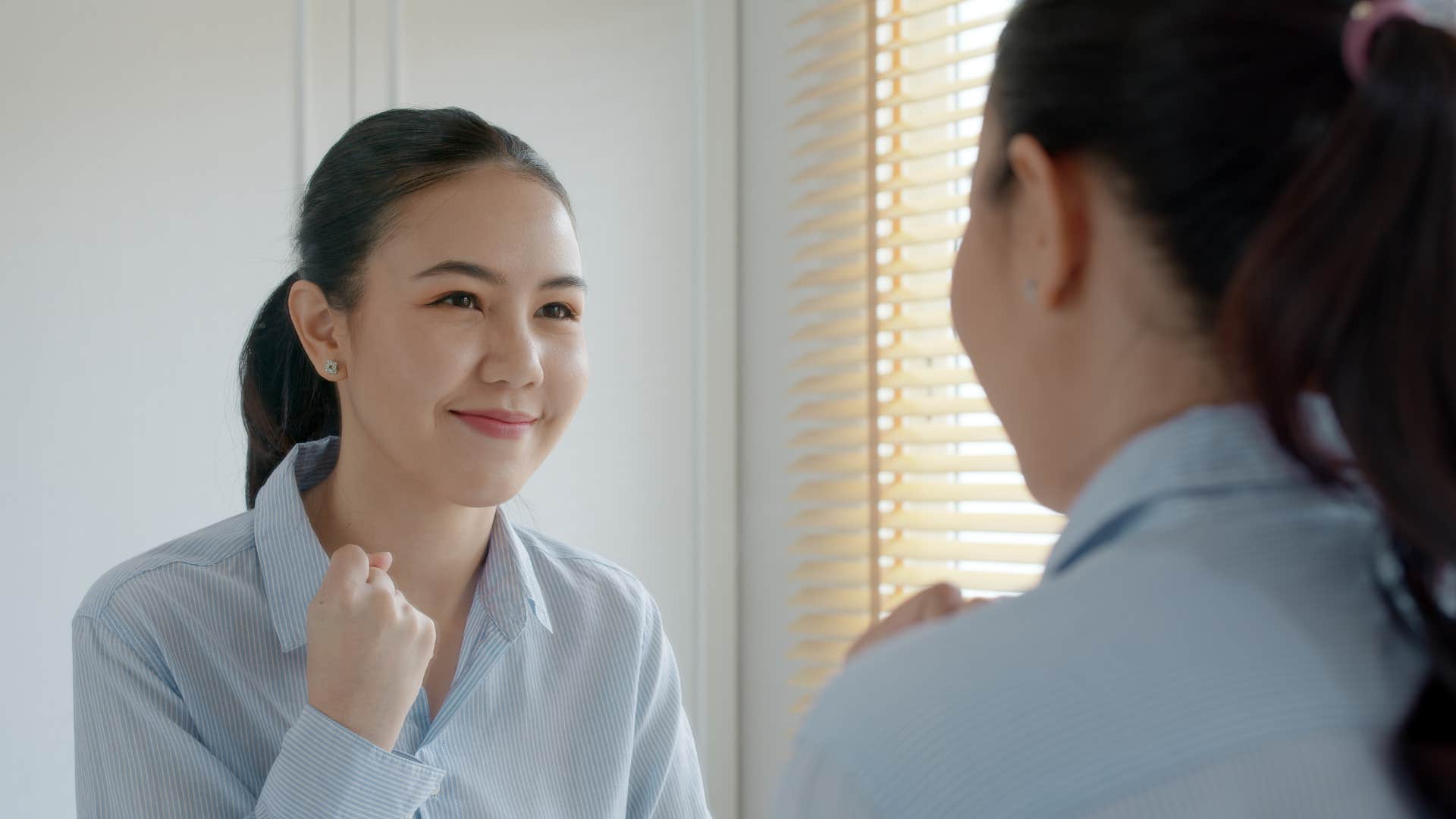 Confident person spends time in front of mirror showing emotional gift