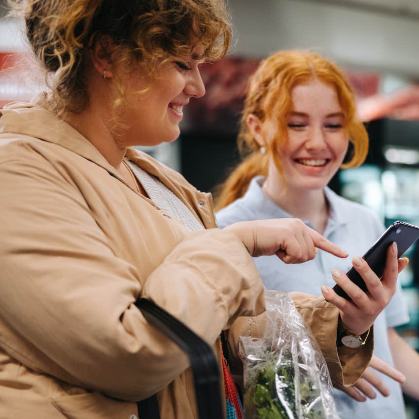 extroverted woman talking to cashier at the grocery store