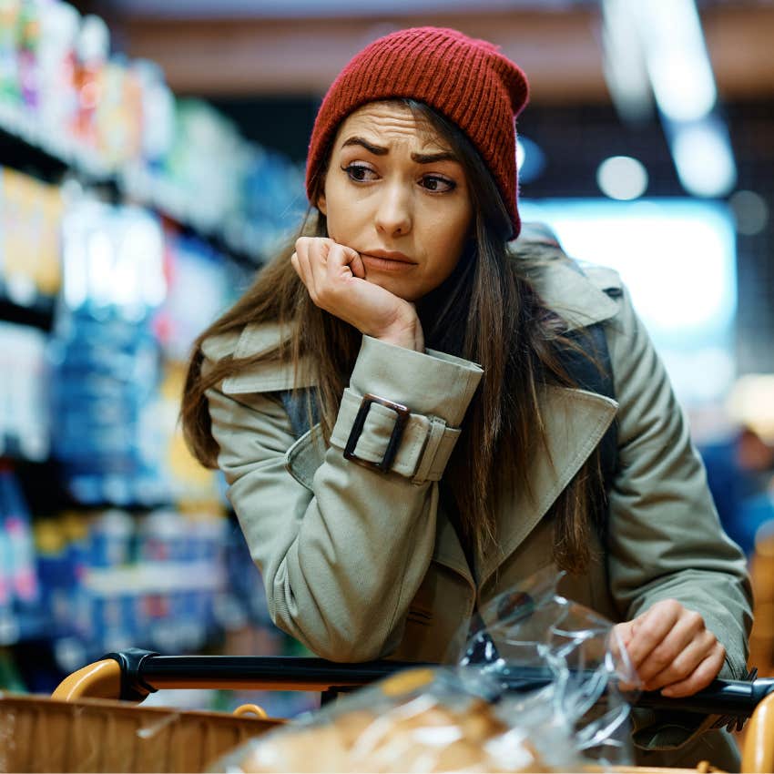 stubborn woman looking worried while shopping at the grocery store