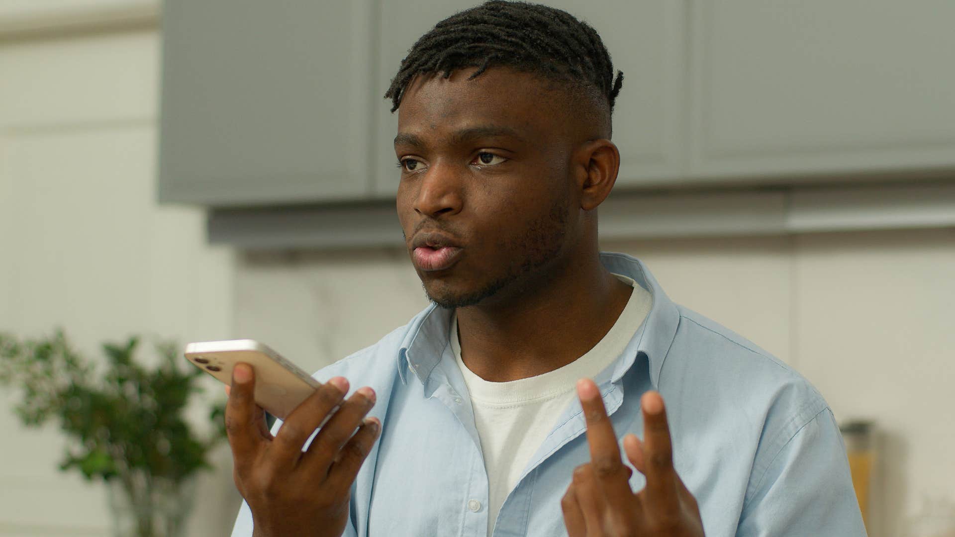 upset man on speakerphone with friend saying the phone works both ways