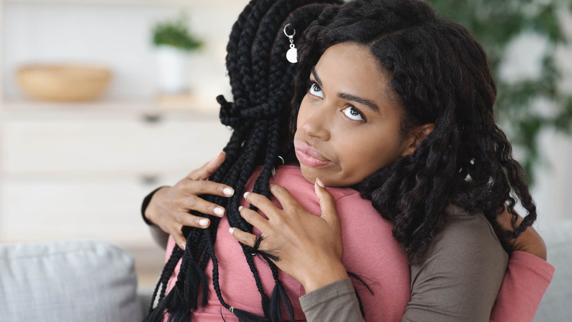 Woman saying "I'm here for you" and rolling her eyes with a friend.
