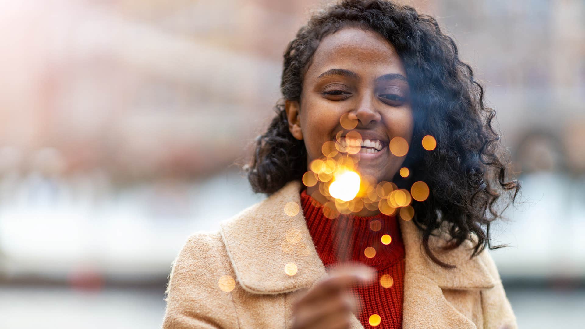 Happy person with sparkler celebrates breakup