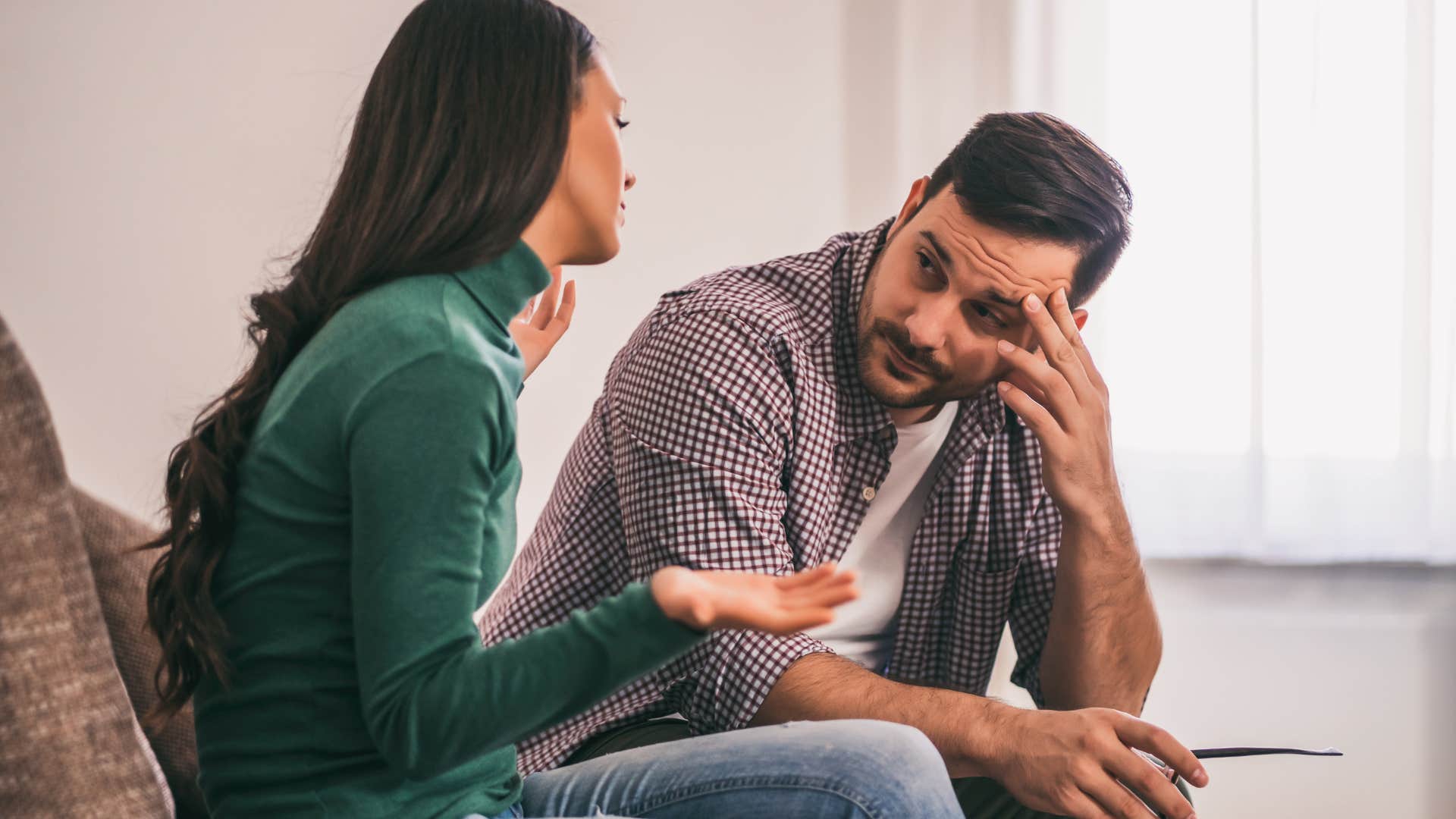 Man who deflects with humor looking at his wife.