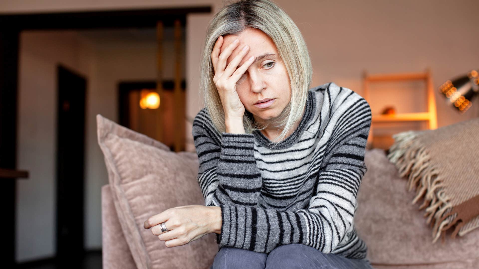 Woman who expects disappointment and abandonment sitting at home.