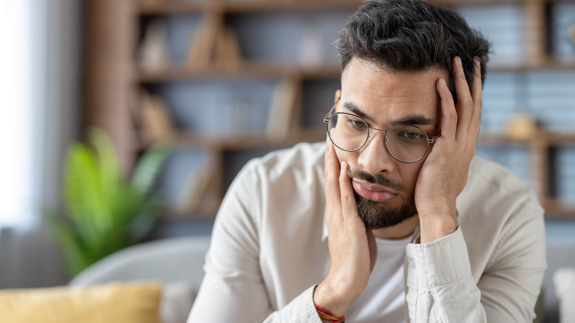 Man who refuses to ask for help sitting alone at home.