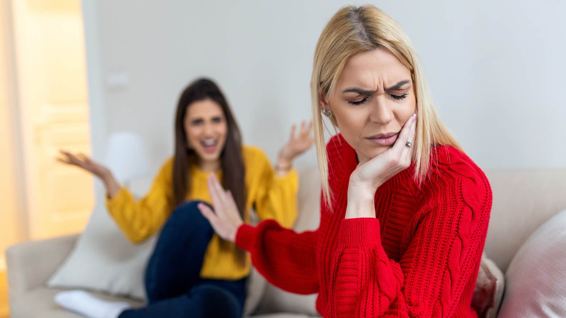 woman putting her hand up to friend saying it's not that serious