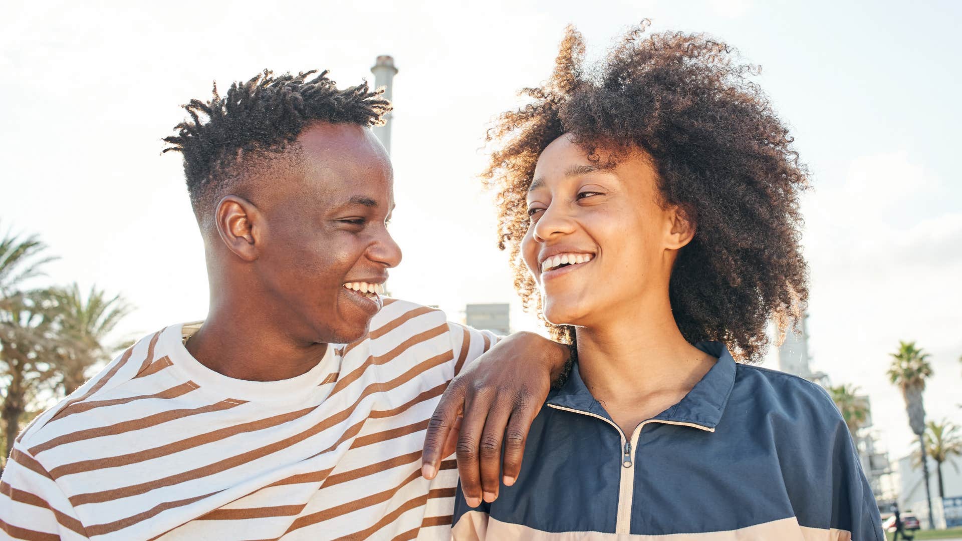 Smiling couple hold eye contact showng cherished people prioritize you