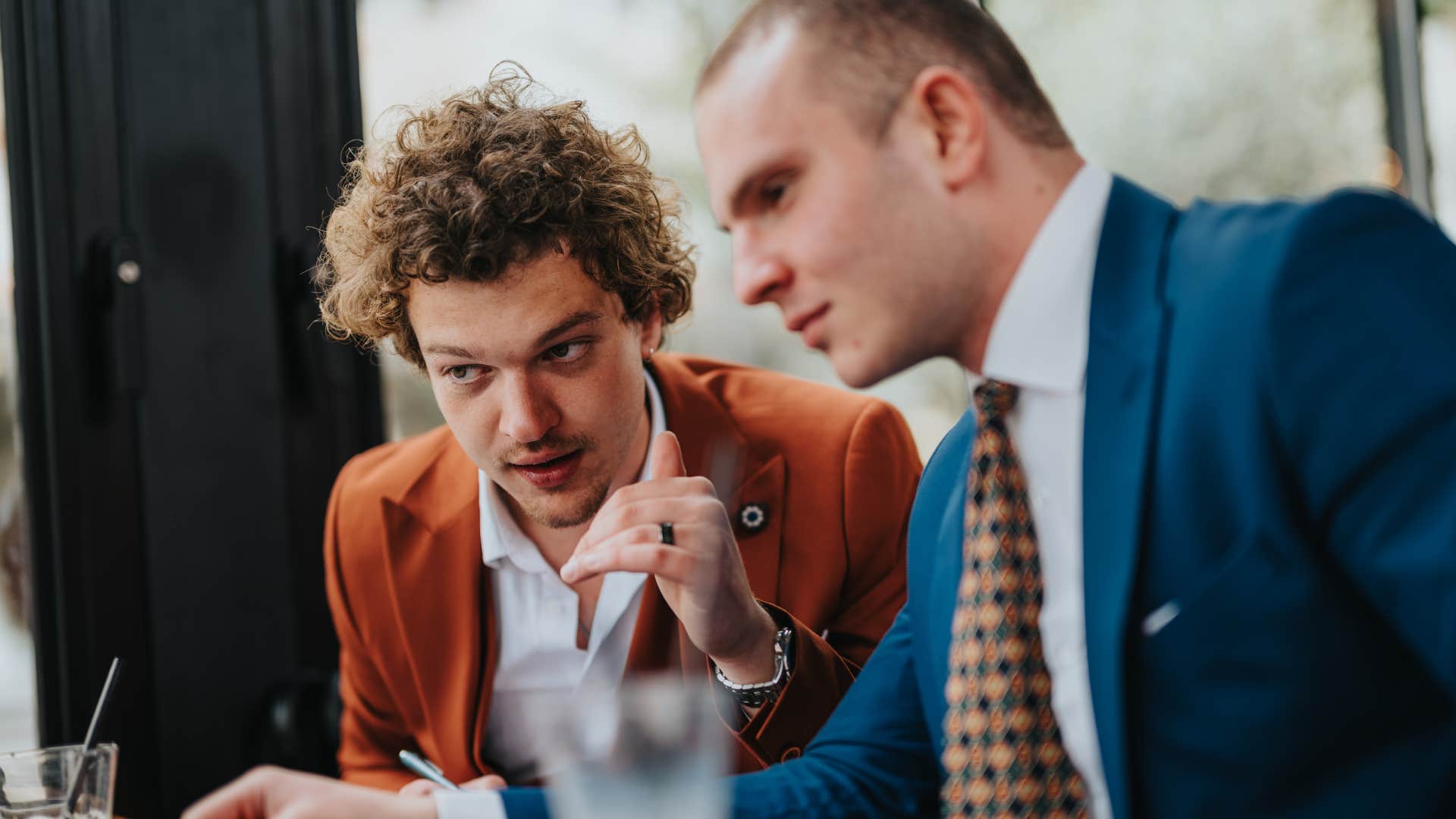 man trying to sound smart telling colleague you have to think more critically about it