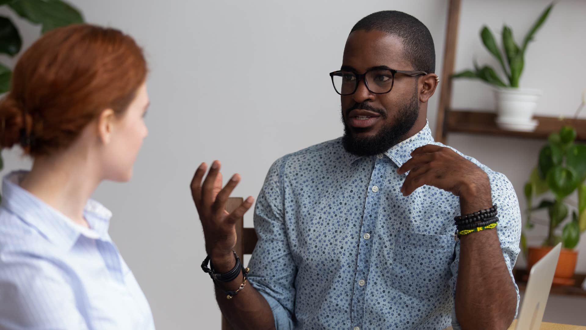 man saying i don't mean to be rude but to colleague at work