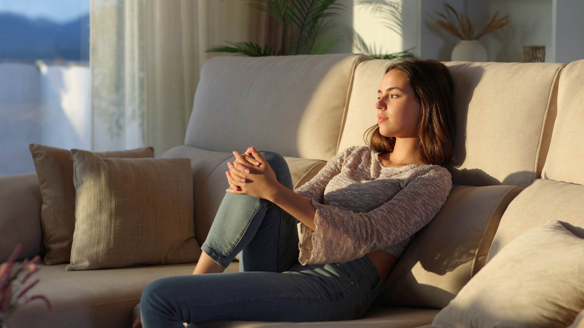 woman sitting alone on couch