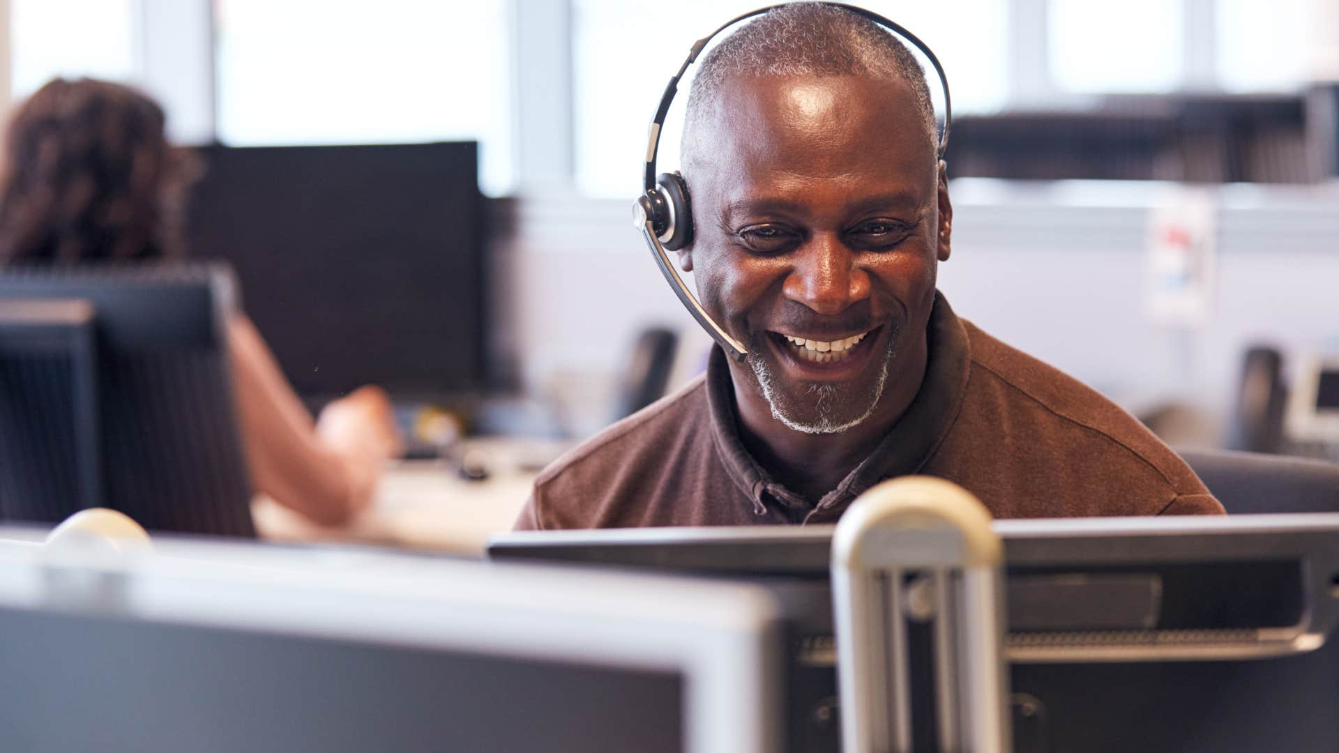 man boosting his creativity while talking on the phone at work