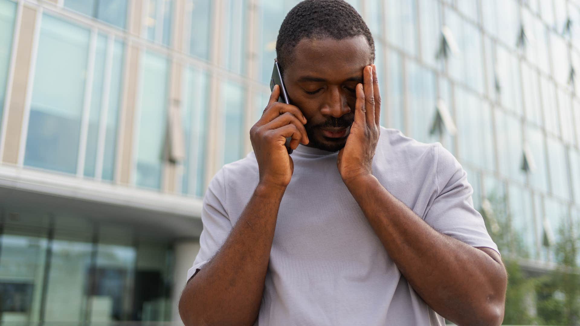 man trying to deal with restlessness while walking around on the phone outside