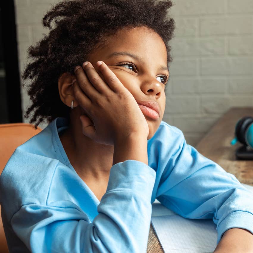 little boy at school understanding that boredom isn't a bad thing