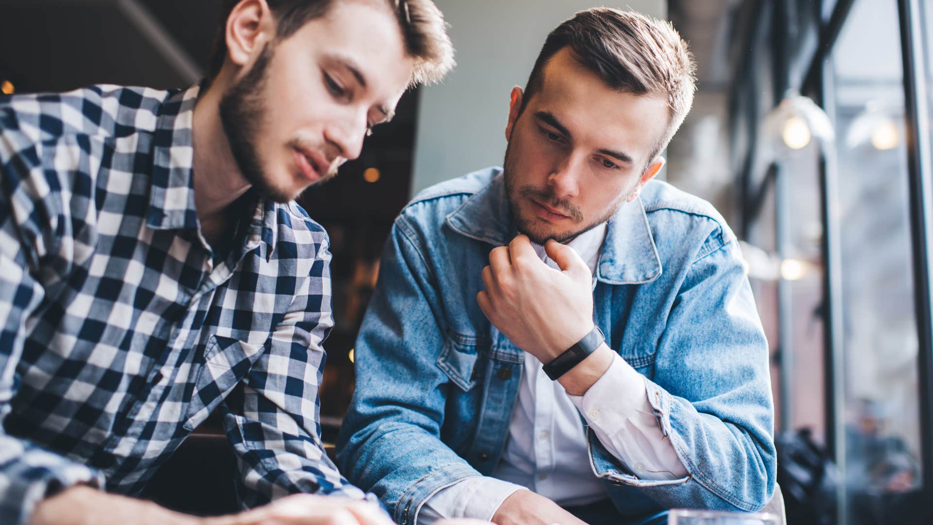 two men having conversation inside cafe