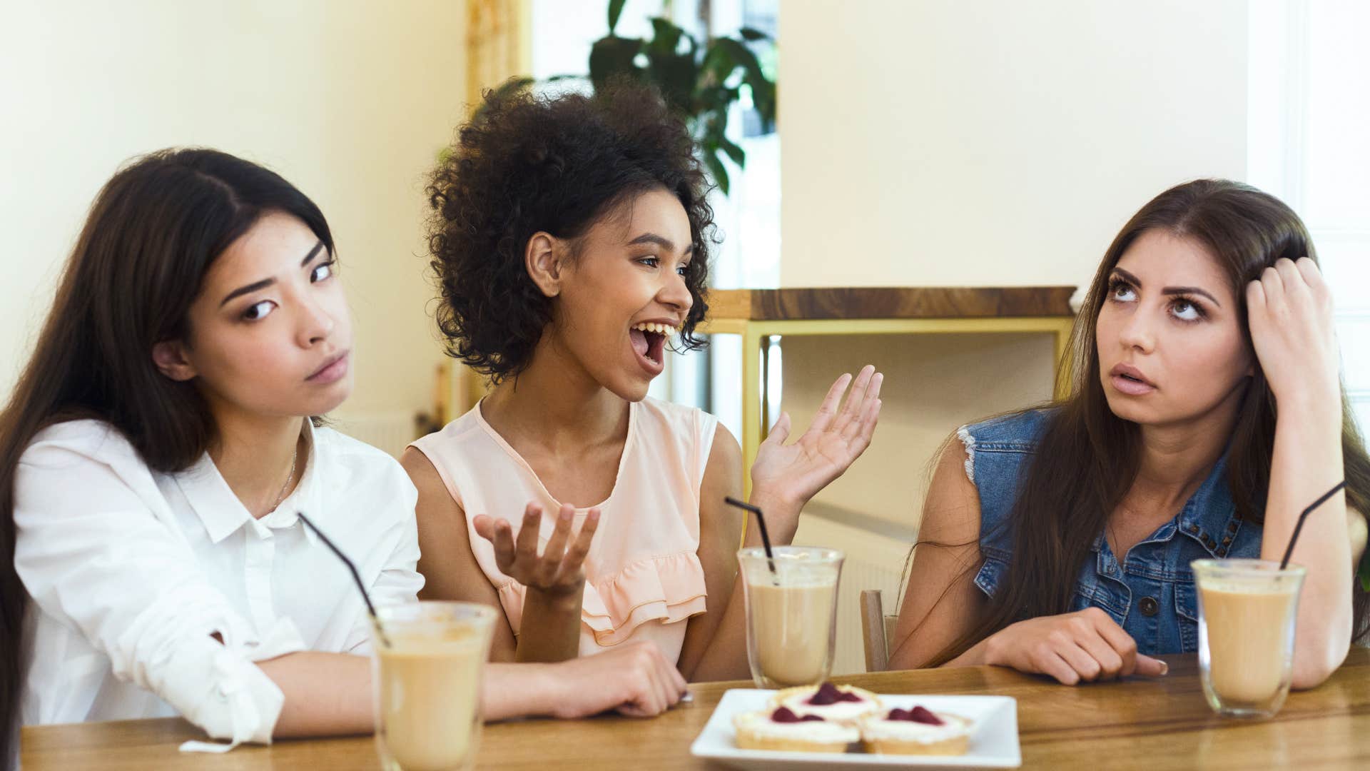 friends annoyed that woman keeps interrupting them during conversation