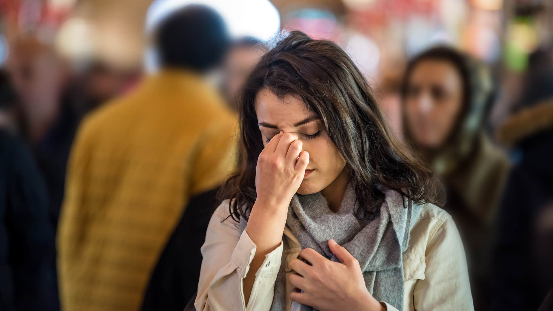 woman stopping crowded spaces looking at her phone