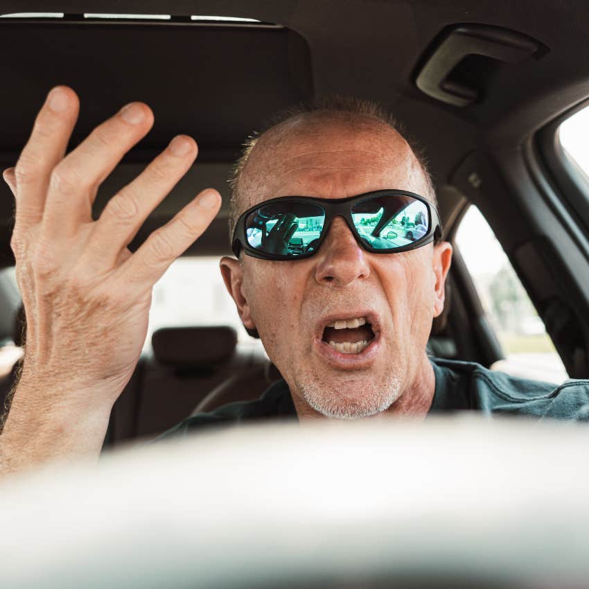 Man yelling in his car while waiting for traffic.