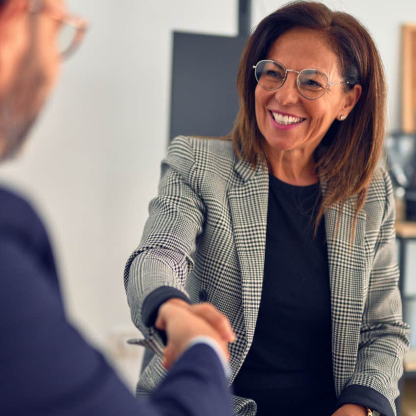 Woman dressing appropriately at work and shaking hands.
