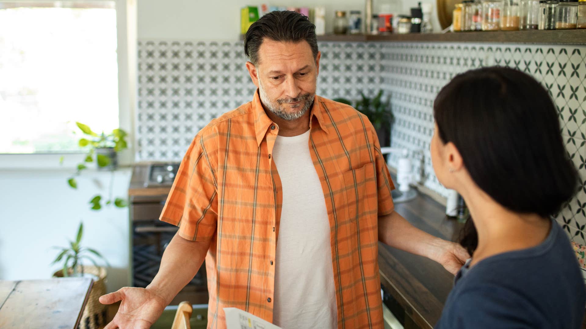 Man shrugging and saying that wasn't wrong to his wife