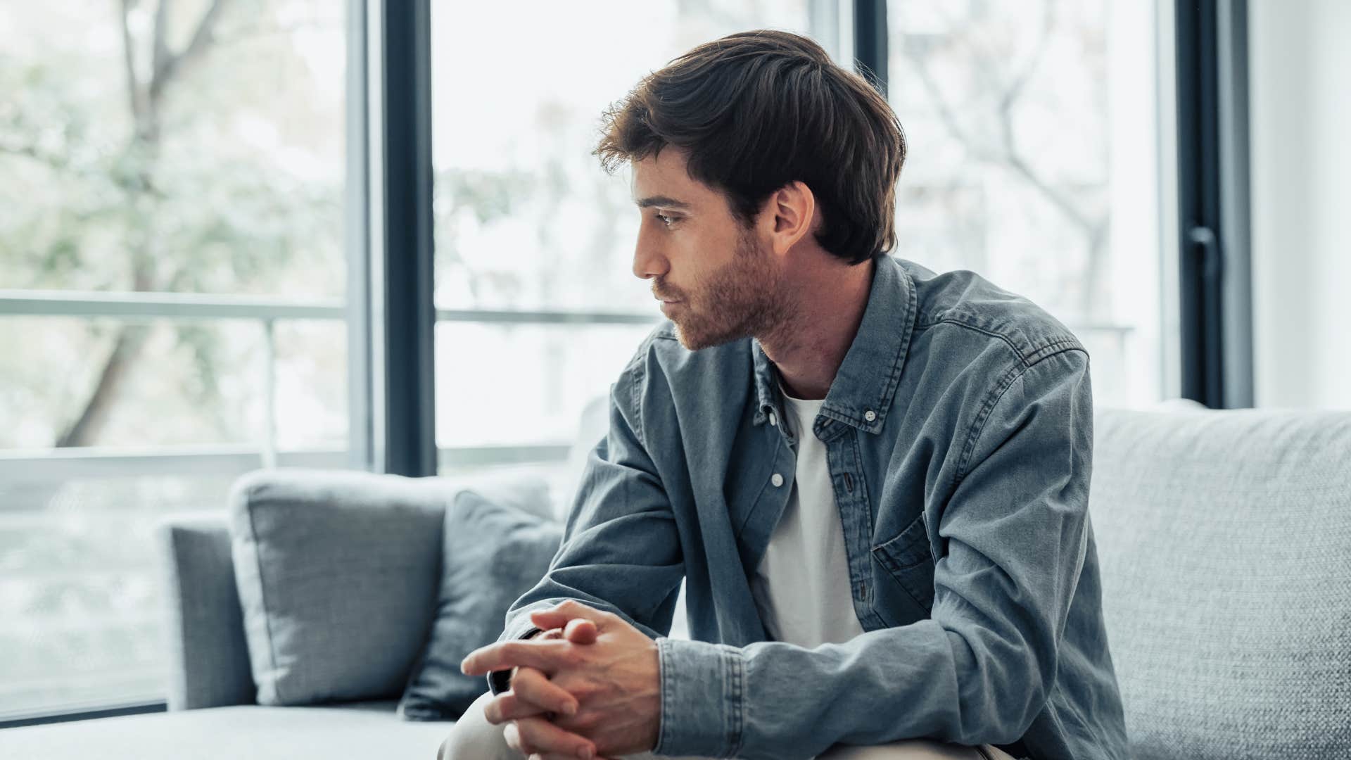 sad man alone at home thinking i don't think anyone will notice