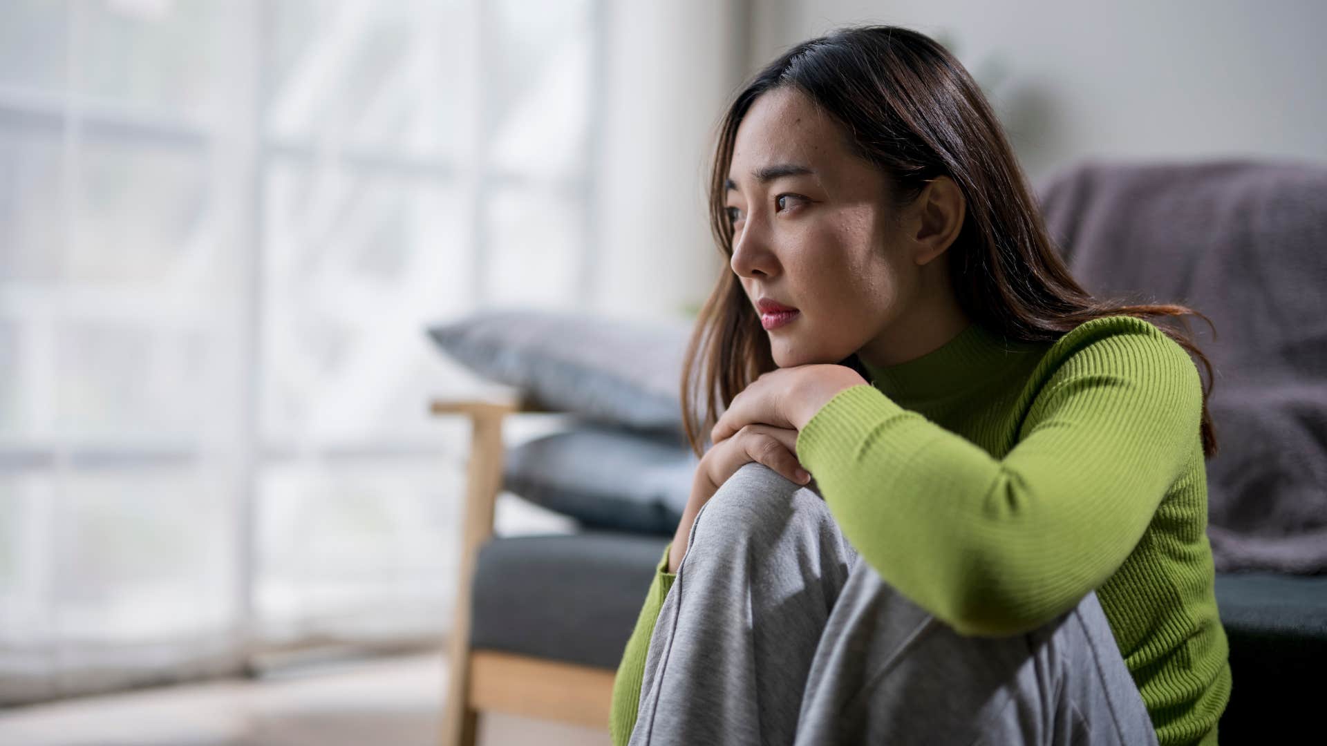 sad woman looking upset thinking i won't want to burden anyone