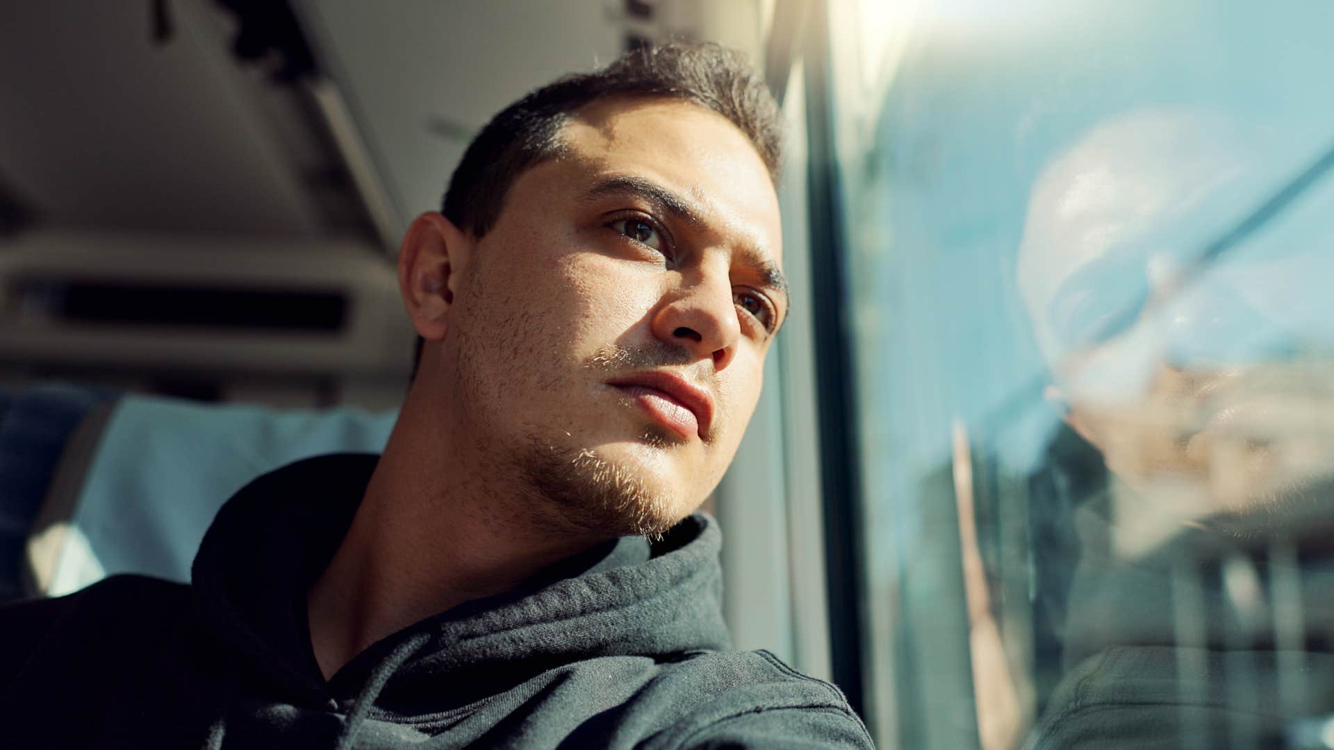 man alone on a train thinking i tend to disappear