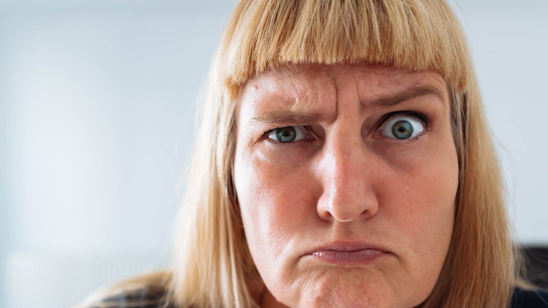 Judgmental woman gives evil eye showing past affects trait men never attracted to