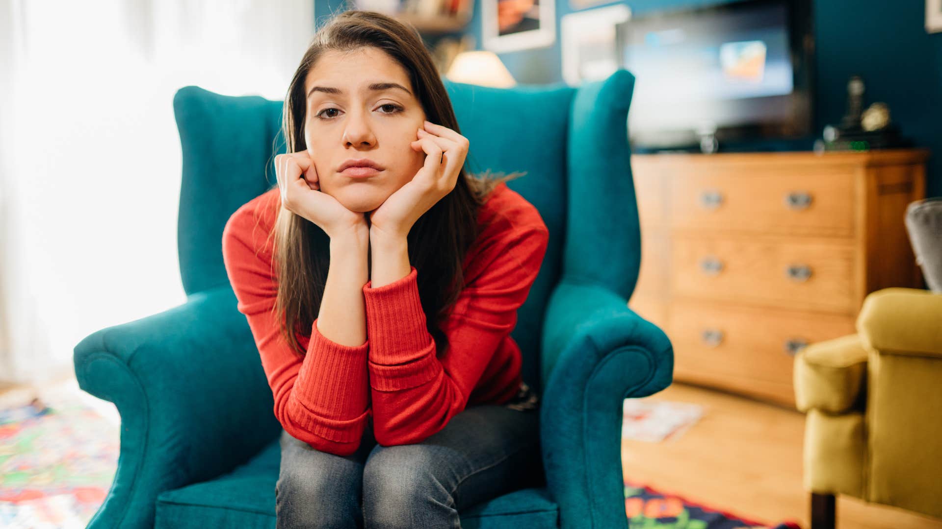 Sad woman sits defensively showing father wound never attracts men