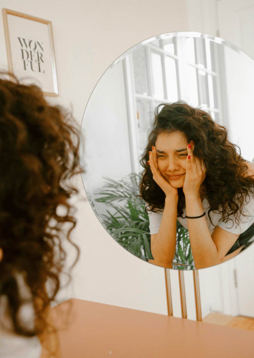 petulant woman staring at her own reflection
