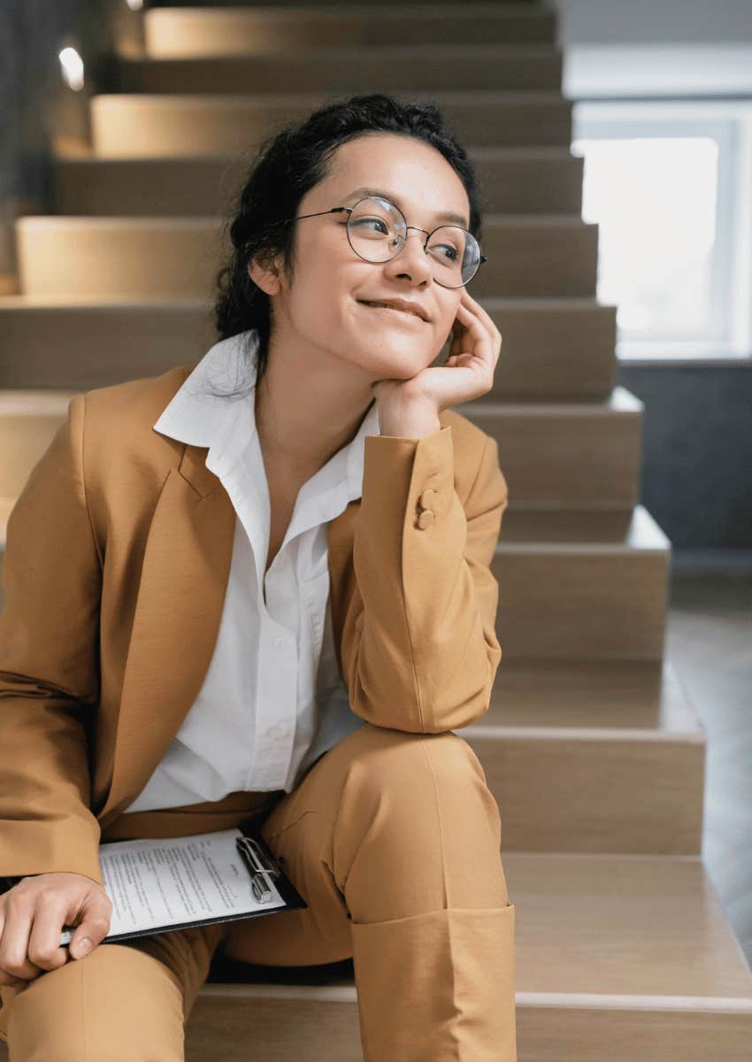 professional woman sitting on stairs