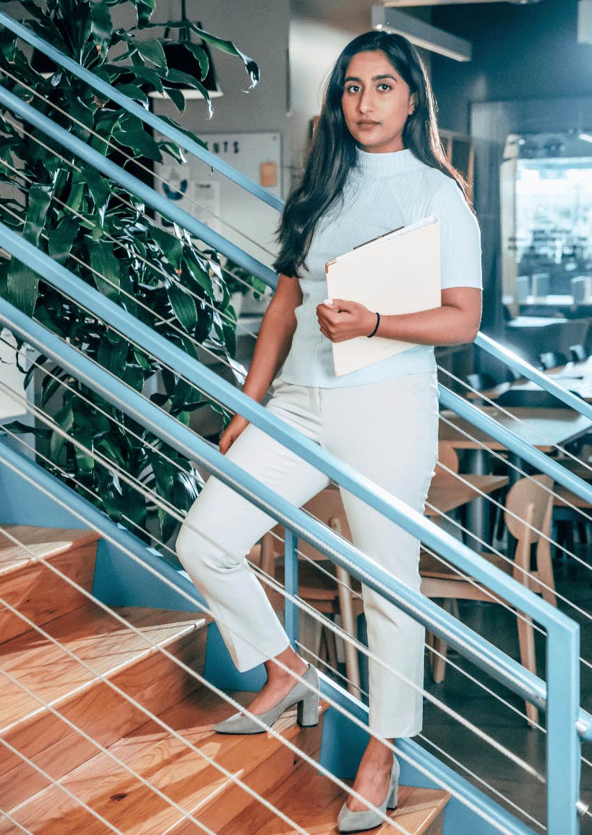 professional young woman posing on stairs