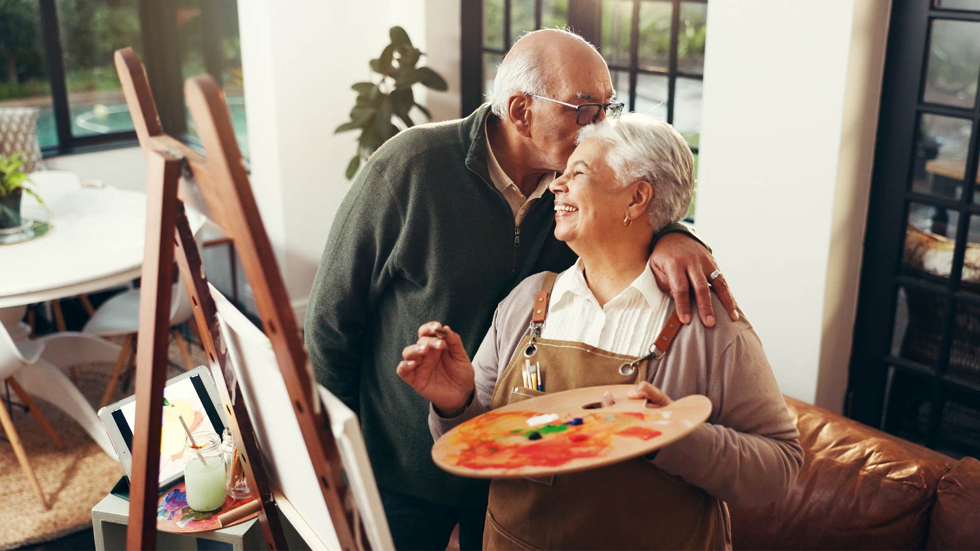 Loving person kisses creative partner showing best way to be happier in marriage