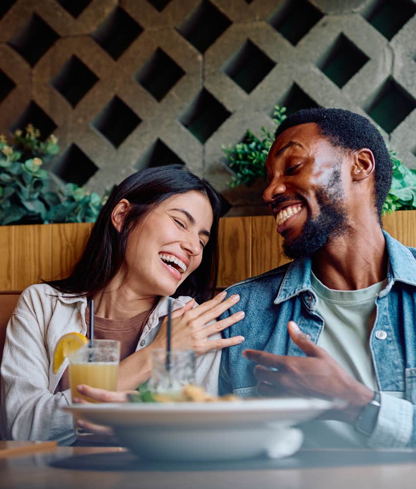 Happy couple laiugh freely while sharing a meal showing habit to build lifelong marriage