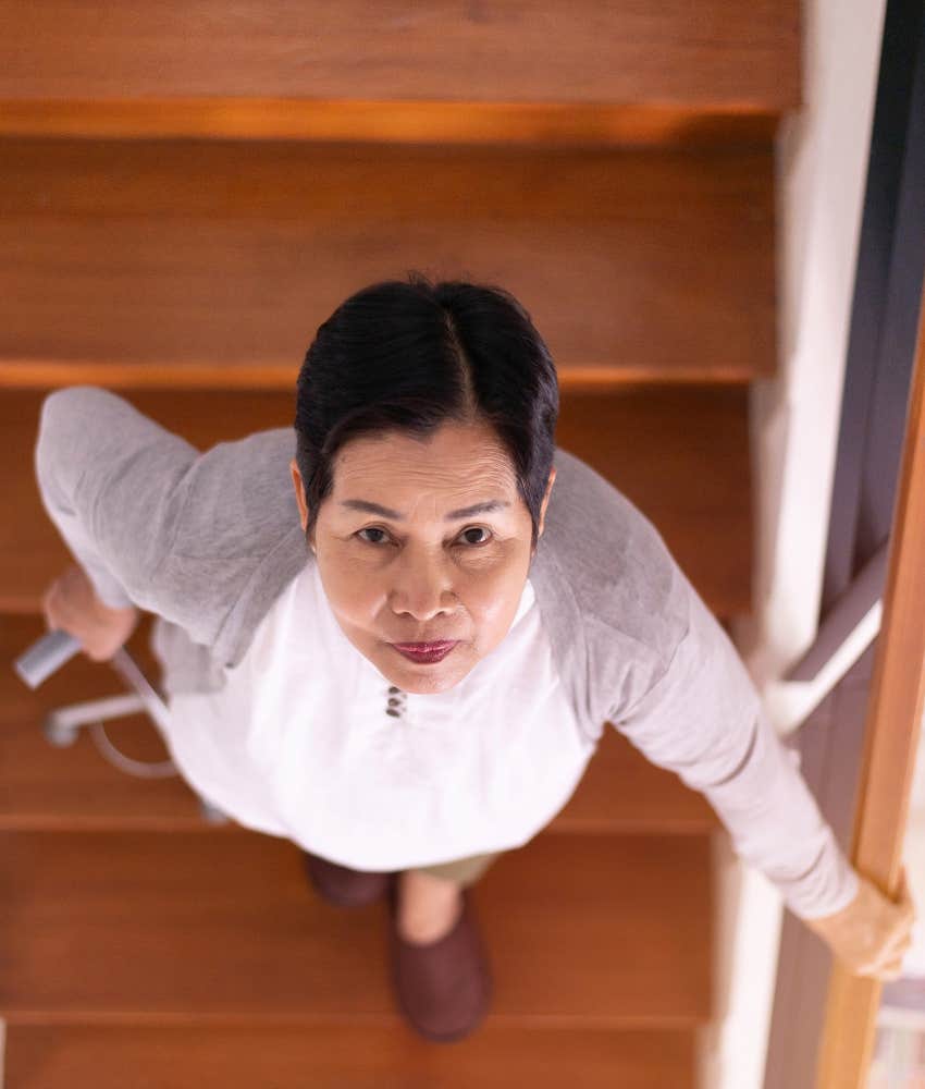 Determined elder on stairs viewed from above showing powerful aging