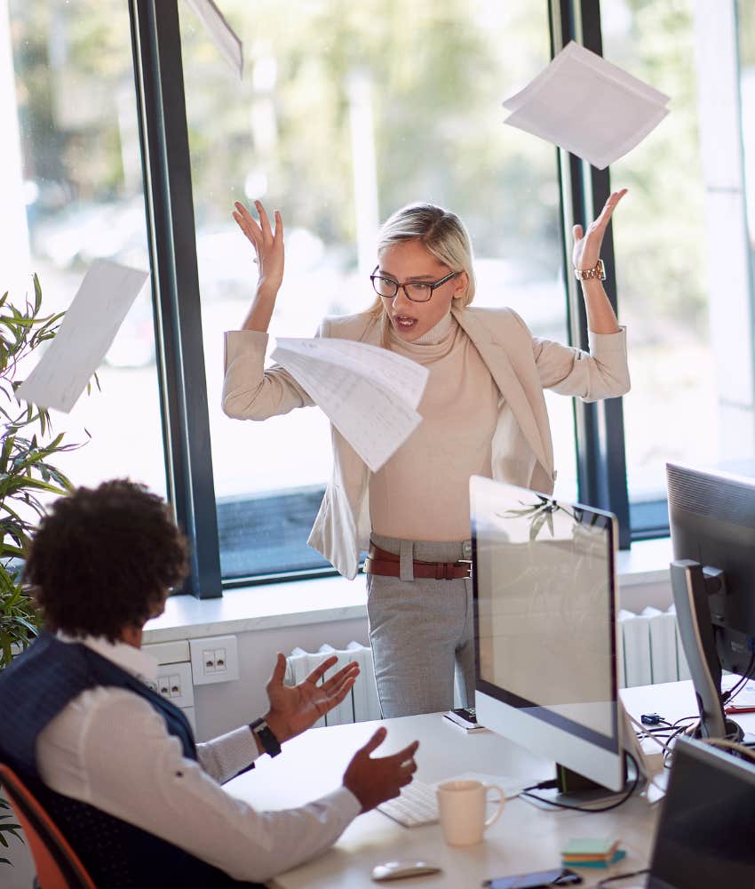 Angry office worker reacts by throwing papers